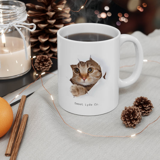 Calling all cat lovers! This cute cat mug has a cat peeking out. This mug is perfect for all cat moms and dads out there. This mug is 11 oz, lead and BPA free, and microwave and dishwasher safe!